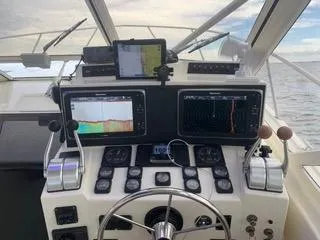 Slide: The Image of 2001 Carolina Classic 35 boat dashboard with navigation screens and controls. - 9