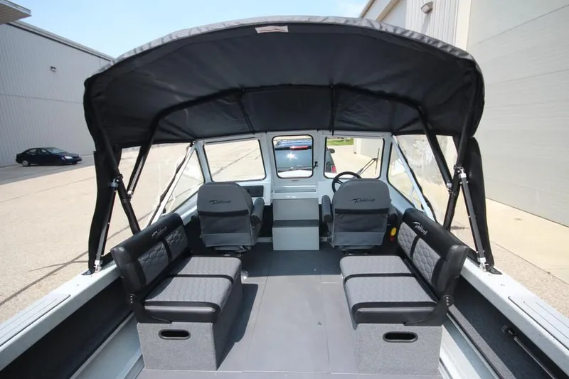 Slide: The Image of 2025 Weldcraft 200 Rebel F150 boat interior with canopy and seating. - 12