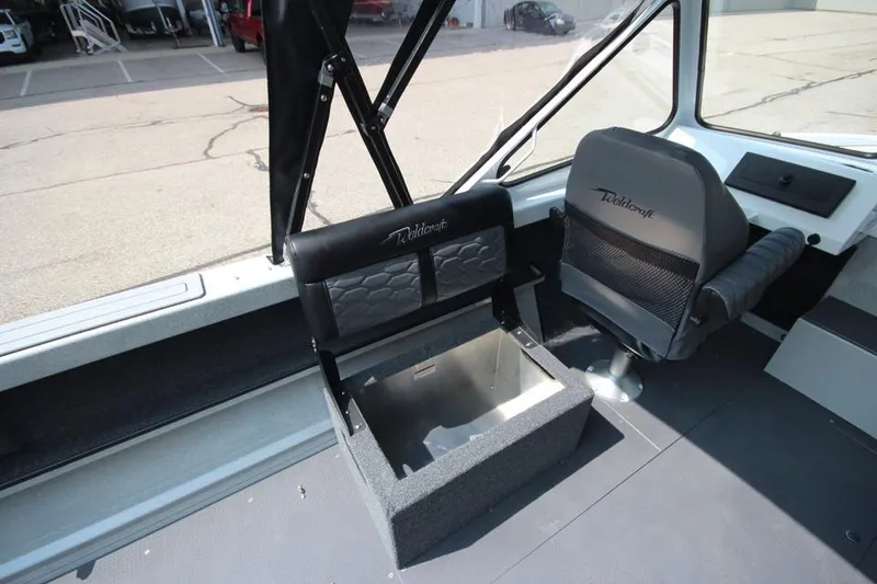 Slide: The Image of Interior of 2025 Weldcraft 200 Rebel F150 boat, featuring seating and storage. - 13