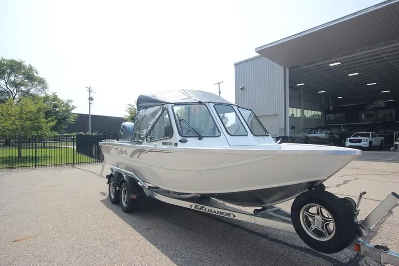 Slide: The Image of 2025 Weldcraft 200 Rebel F150 boat on trailer outside dealership. - 2