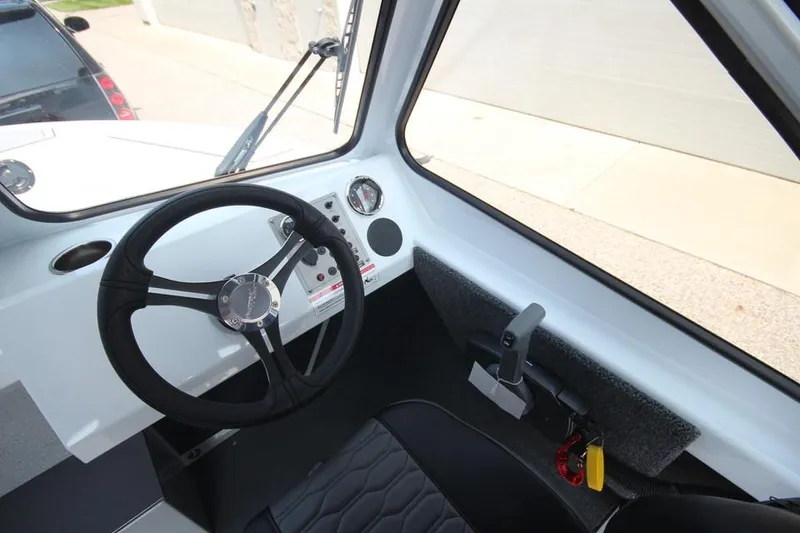 Slide: The Image of 2025 Weldcraft 200 Rebel F150 boat interior with steering wheel and dashboard controls. - 21