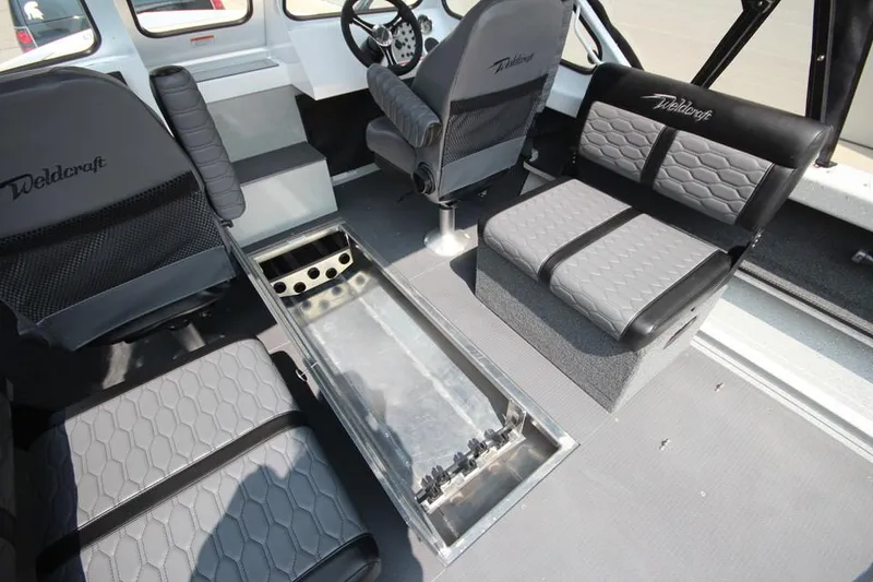 Slide: The Image of Interior of 2025 Weldcraft 200 Rebel F150 boat with gray seating and steering wheel. - 25