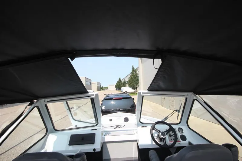 Slide: The Image of Interior view of 2025 Weldcraft 200 Rebel F150 boat, featuring steering wheel and dashboard. - 26