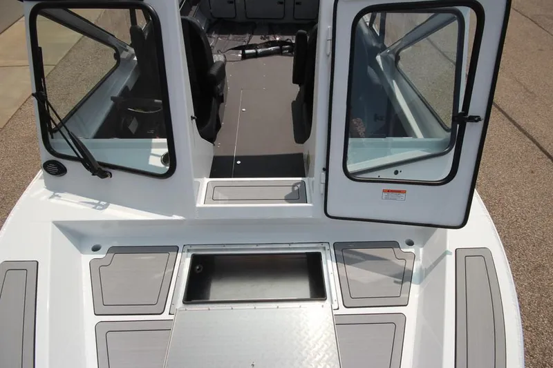Slide: The Image of 2025 Weldcraft 200 Rebel F150 boat interior with open doors and storage compartments. - 28