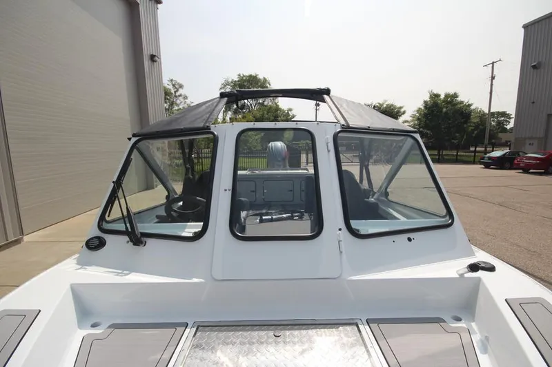Slide: The Image of 2025 Weldcraft 200 Rebel F150 boat, front view, docked outdoors. - 29