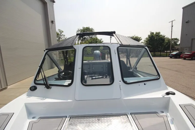 Slide: The Image of 2025 Weldcraft 200 Rebel F150 boat, front view, parked outdoors. - 30
