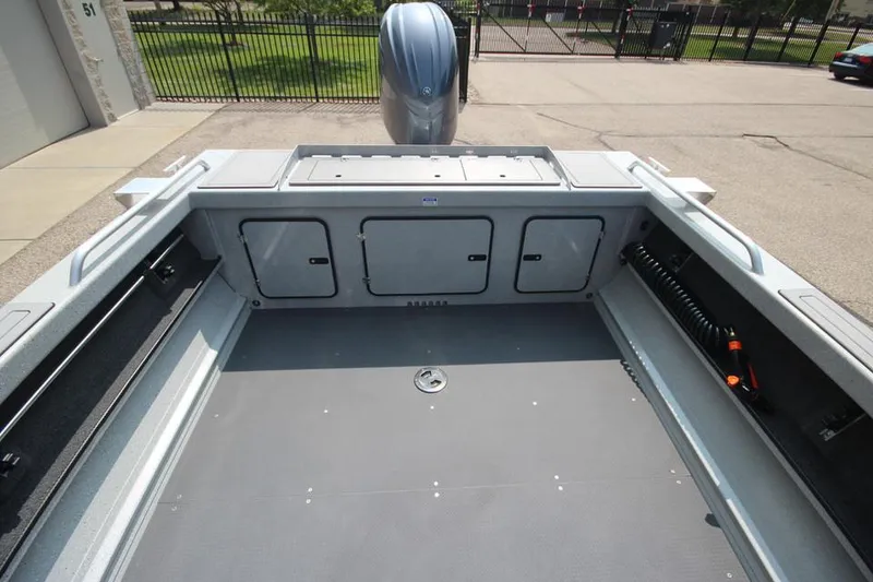 Slide: The Image of 2025 Weldcraft 200 Rebel F150 boat interior with storage compartments and motor. - 8
