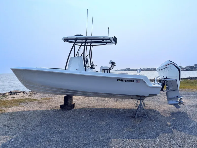 Slide: The Image of 2025 Contender 24 Sport boat on display by the water. - 17