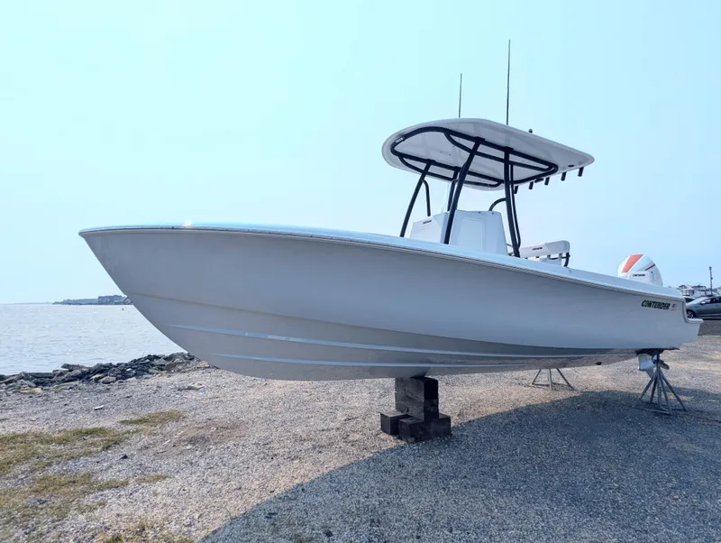 Slide: The Image of 2025 Contender 24 Sport boat on shore, featuring sleek design and sturdy build. - 18