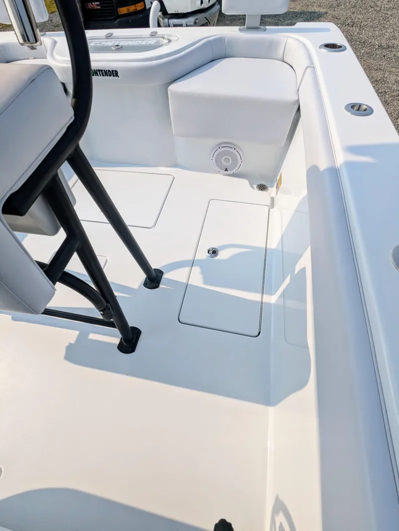 Slide: The Image of 2025 Contender 24 Sport boat interior with seating and storage compartments. - 2