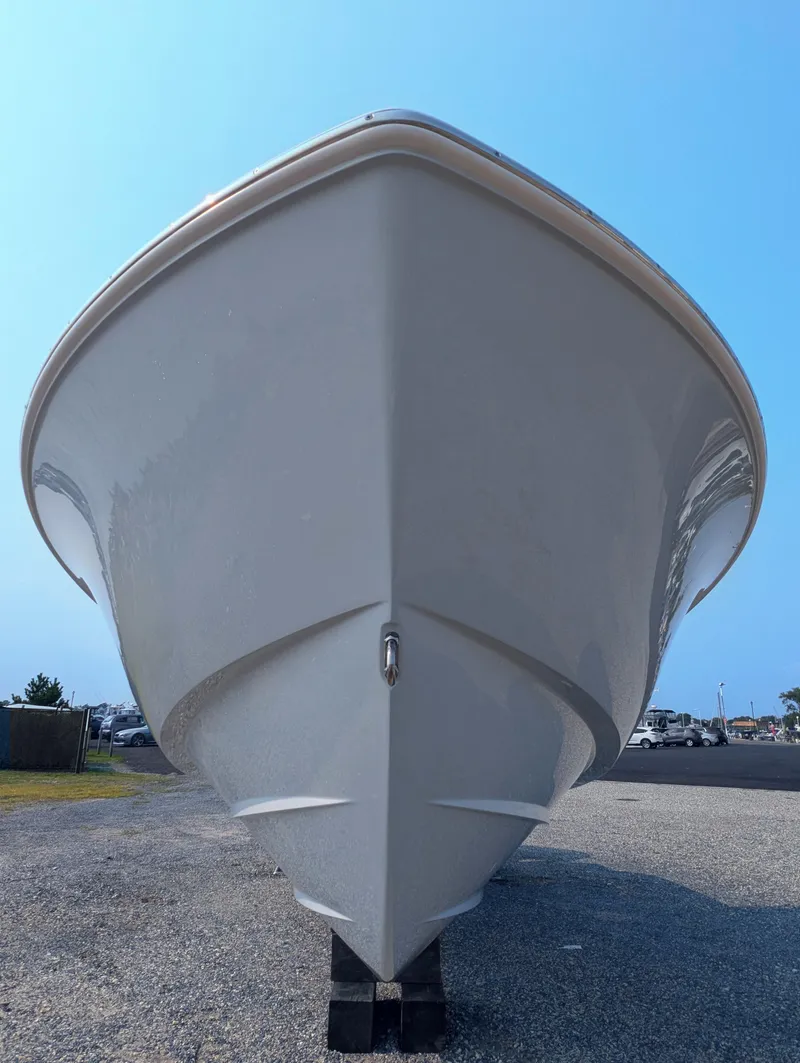 Slide: The Image of 2025 Contender 24 Sport boat, front view, displayed on gravel lot. - 28