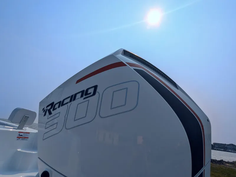 Slide: The Image of 2025 Contender 24 Sport boat with Racing 300 engine under bright sun. - 34