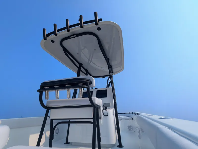 Slide: The Image of 2025 Contender 24 Sport boat, featuring sleek design and modern T-top against clear blue sky. - 46