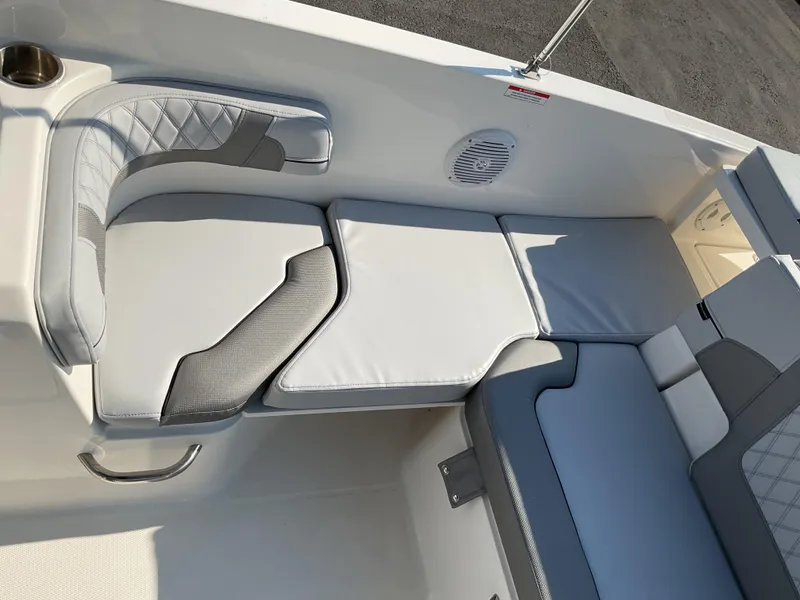Slide: The Image of 2025 Bayliner VR6 Bowrider OB interior seating with gray and white cushions. - 10