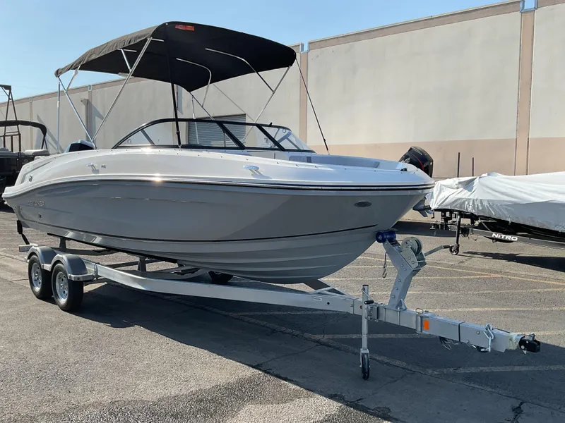 Slide: The Image of 2025 Bayliner VR6 Bowrider OB on trailer, parked outdoors with canopy. - 3