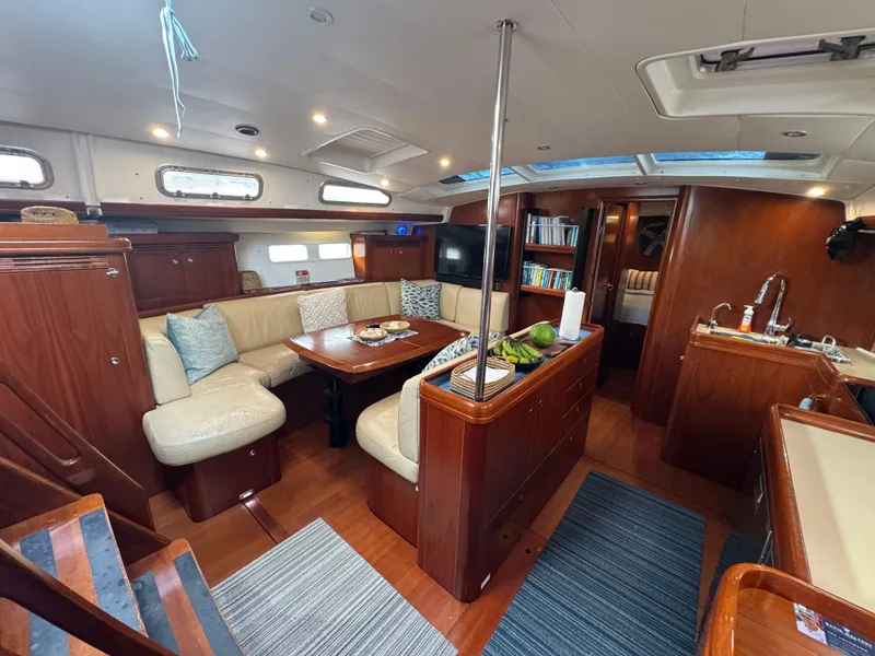 Slide: The Image of Interior of 2005 Beneteau 523 Oceanis yacht with elegant wood finish and cozy seating area. - 10