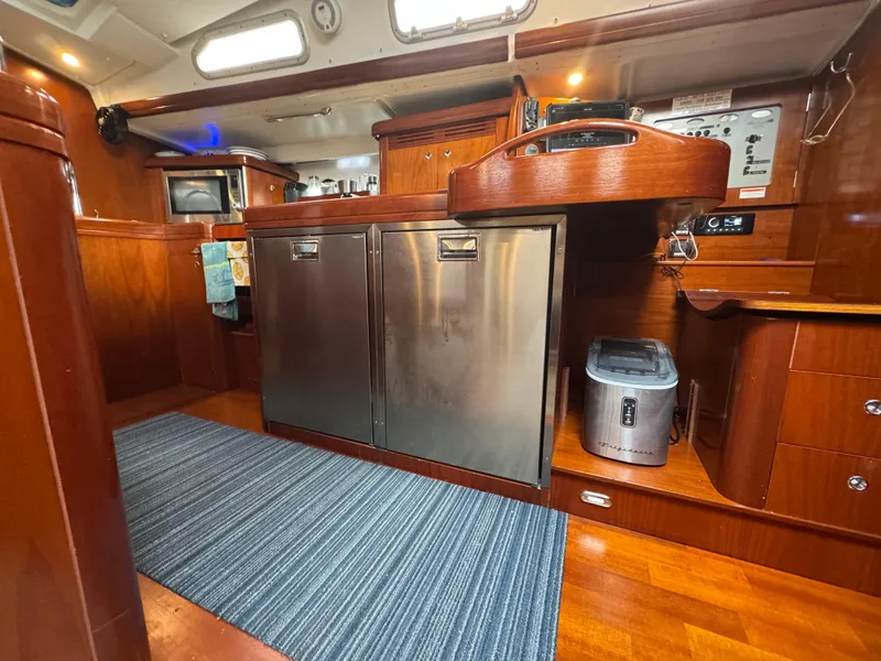 Slide: The Image of Interior of 2005 Beneteau 523 Oceanis yacht with modern kitchen and wooden cabinetry. - 13