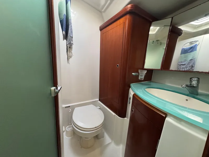 Slide: The Image of Bathroom interior of 2005 Beneteau 523 Oceanis yacht with modern fixtures and wood cabinetry. - 16