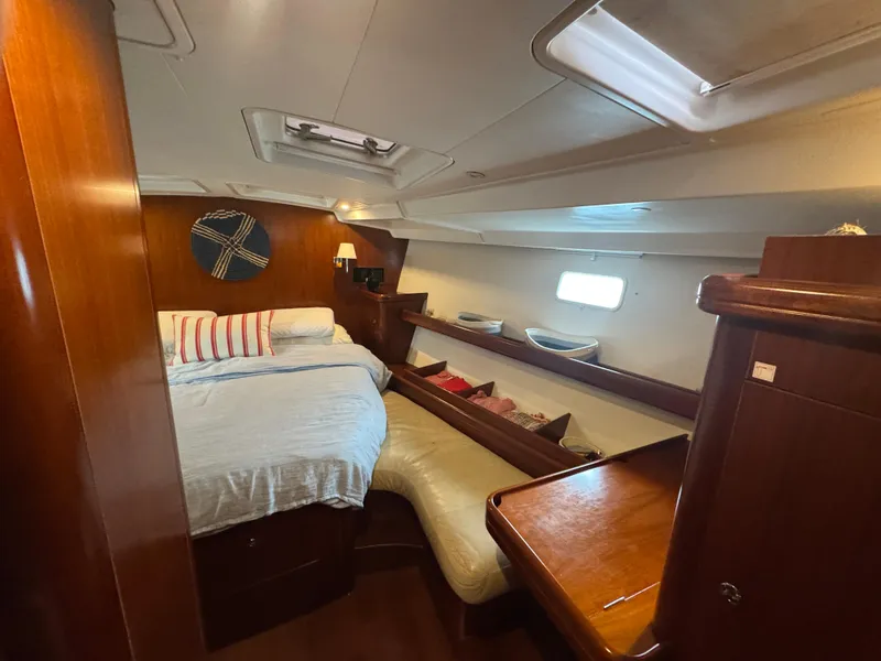Slide: The Image of Luxurious cabin interior of 2005 Beneteau 523 Oceanis yacht with cozy bed and wooden furnishings. - 18