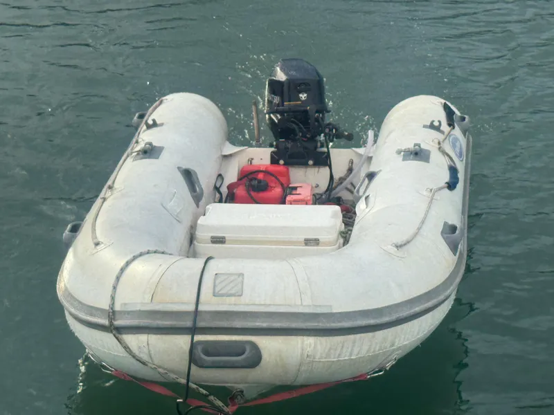 Slide: The Image of Inflatable dinghy with outboard motor on water, associated with 2005 Beneteau 523 Oceanis. - 24