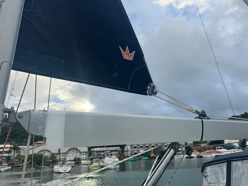 Slide: The Image of Sailboat Beneteau 523 Oceanis 2005 with marina backdrop and cloudy sky. - 25