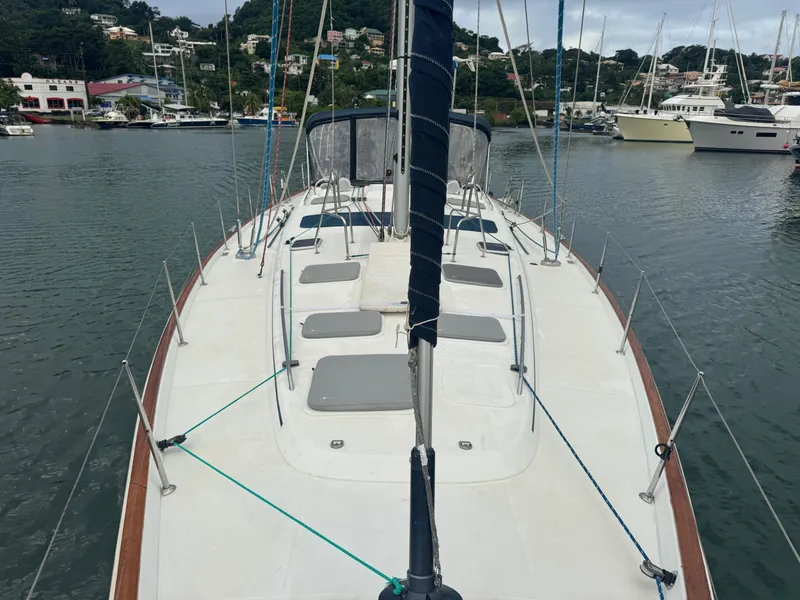 Slide: The Image of 2005 Beneteau 523 Oceanis sailboat docked in a marina, showcasing spacious deck layout. - 28