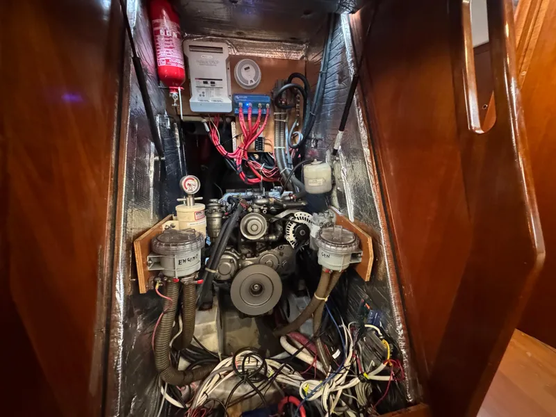 Slide: The Image of Engine compartment of 2005 Beneteau 523 Oceanis sailboat, showcasing wiring and mechanical components. - 32