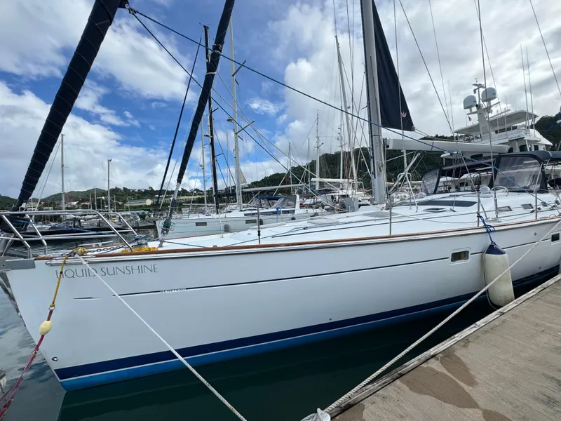 Slide: The Image of 2005 Beneteau 523 Oceanis sailboat docked in a marina under cloudy skies. - 4