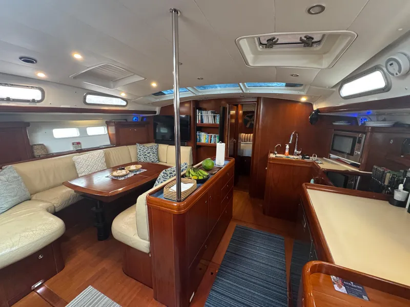 Slide: The Image of Interior of 2005 Beneteau 523 Oceanis yacht with elegant wood finish and cozy seating area. - 6
