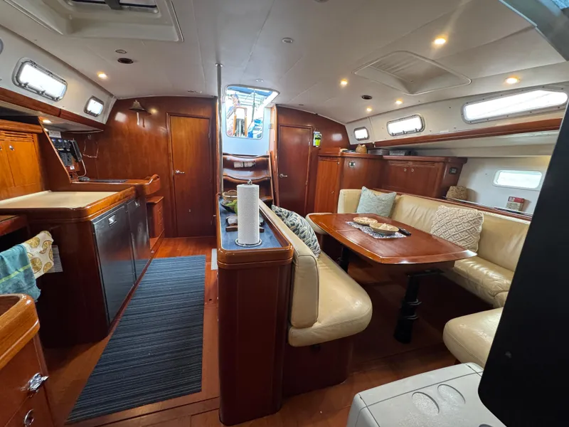 Slide: The Image of Interior of 2005 Beneteau 523 Oceanis yacht with wood finishes and comfortable seating. - 7