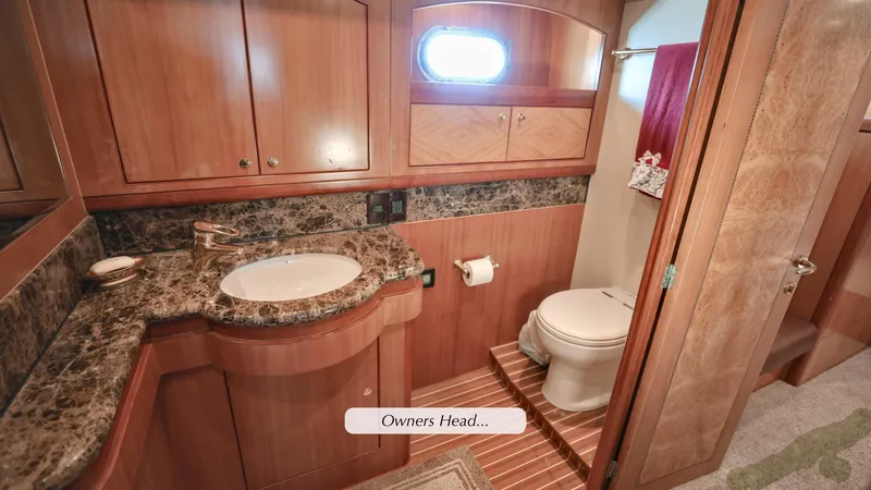 Slide: The Image of Luxurious 2004 Grand Harbour motor yacht bathroom with wood cabinetry and marble countertop. - 12