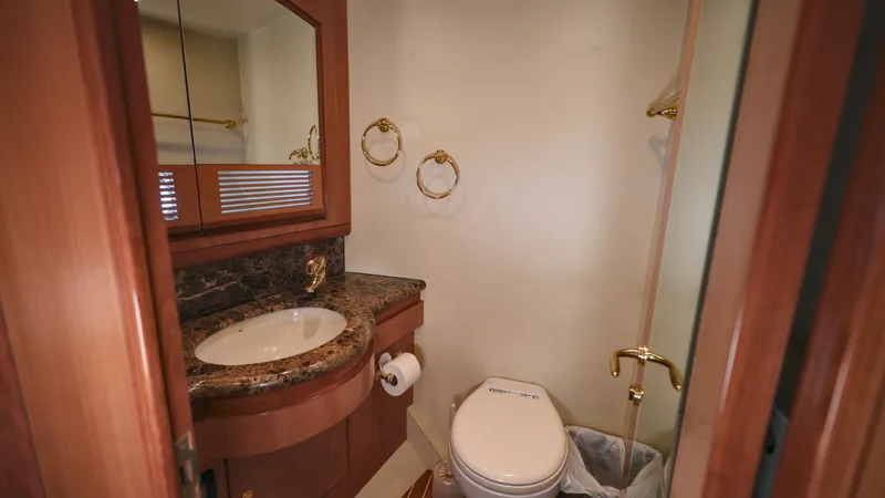 Slide: The Image of Luxurious bathroom in 2004 Grand Harbour Motor Yacht with marble countertop and gold fixtures. - 15