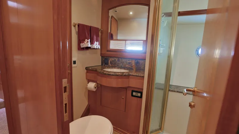 Slide: The Image of Luxurious bathroom in 2004 Grand Harbour Motor Yacht with wood accents and modern fixtures. - 17