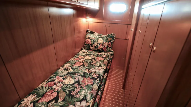Slide: The Image of Luxurious 2004 Grand Harbour motor yacht cabin with floral bedding and wooden interior. - 20