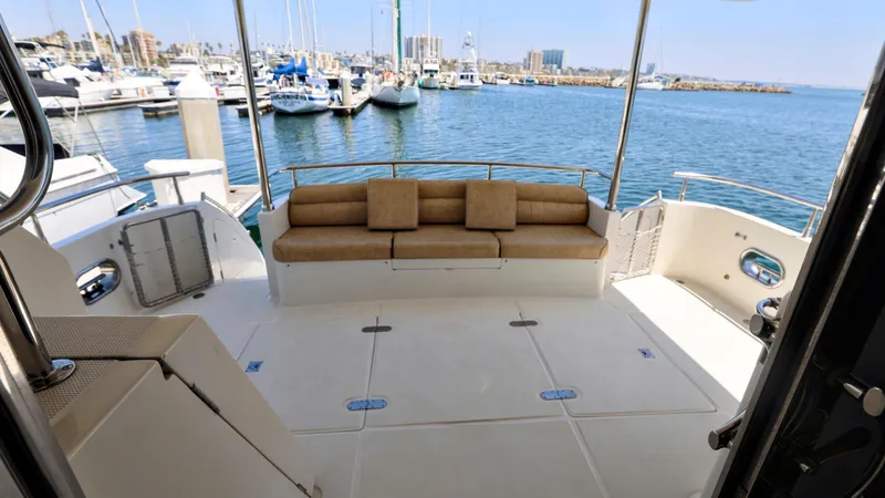 Slide: The Image of 2004 Grand Harbour Motor Yacht deck with seating, overlooking marina and ocean view. - 21