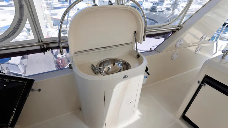 Slide: The Image of 2004 Grand Harbour Motor Yacht sink area with stainless steel basin and storage. - 28