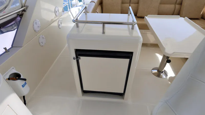 Slide: The Image of 2004 Grand Harbour Motor Yacht interior with seating, table, and storage unit. - 29