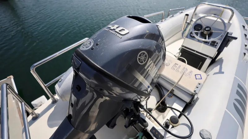 Slide: The Image of Outboard motor on a 2004 Grand Harbour Motor Yacht, docked on calm water. - 30