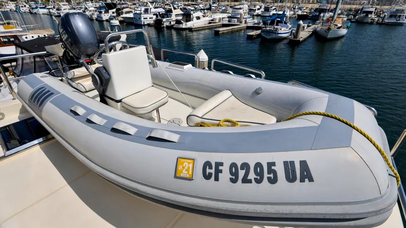 Slide: The Image of Inflatable boat docked at marina, near 2004 Grand Harbour Motor Yacht. - 31