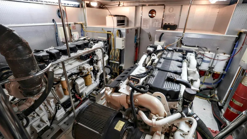 Slide: The Image of Engine room of 2004 Grand Harbour Motor Yacht, showcasing dual engines and mechanical systems. - 36