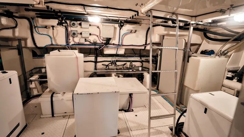 Slide: The Image of Engine room of a 2004 Grand Harbour Motor Yacht, featuring equipment and storage units. - 37