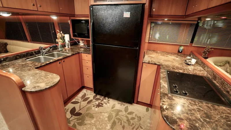 Slide: The Image of Luxurious kitchen interior of 2004 Grand Harbour Motor Yacht with marble countertops and modern appliances. - 4