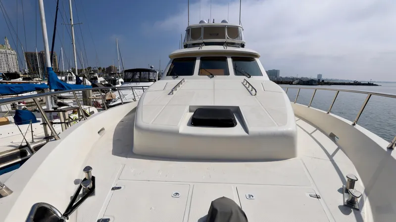Slide: The Image of Grand Harbour 2004 motor yacht docked at marina, showcasing sleek design and spacious deck. - 41
