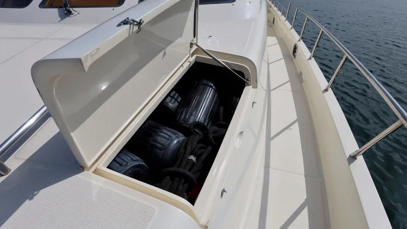 Slide: The Image of Open storage compartment on 2004 Grand Harbour Motor Yacht deck, revealing equipment inside. - 42