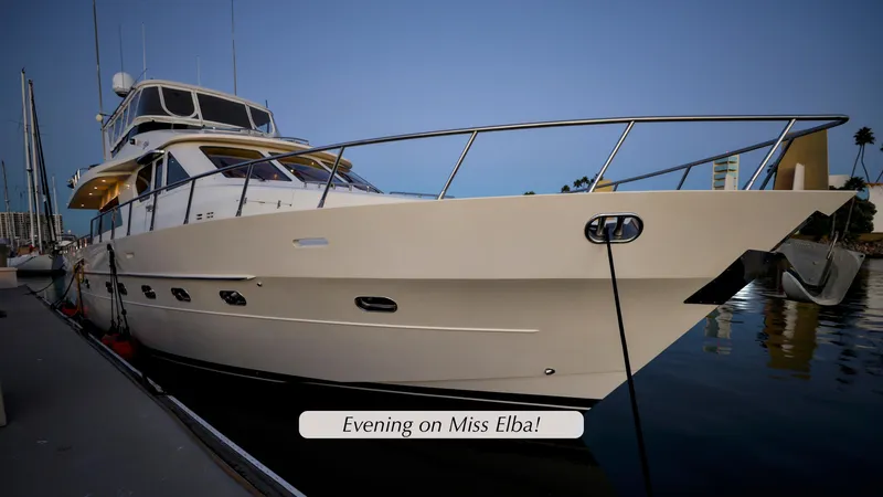 Slide: The Image of Grand Harbour 2004 motor yacht docked at sunset, labeled "Evening on Miss Elba." - 44