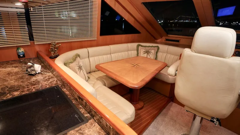 Slide: The Image of Luxurious 2004 Grand Harbour Motor Yacht interior with elegant seating and dining area. - 6
