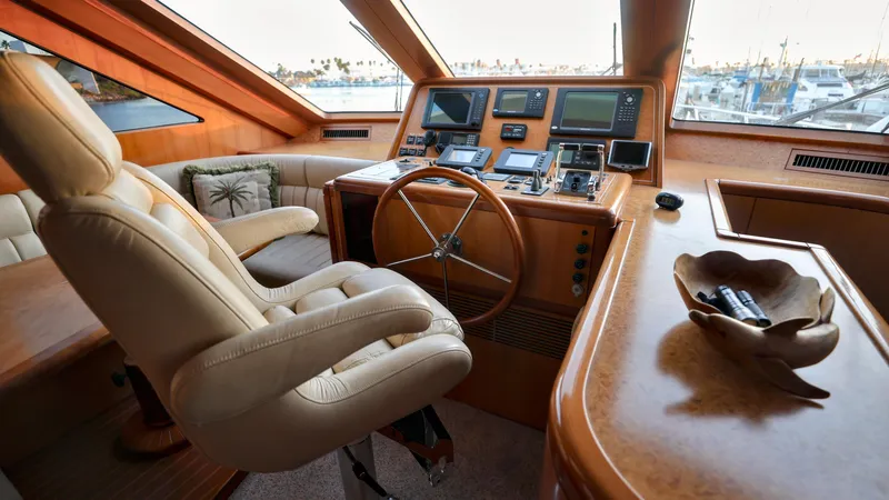Slide: The Image of Luxurious 2004 Grand Harbour motor yacht helm with leather seating and advanced navigation equipment. - 7