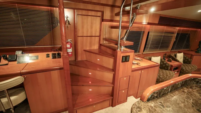 Slide: The Image of Luxurious 2004 Grand Harbour motor yacht interior with wooden stairs and elegant furnishings. - 9