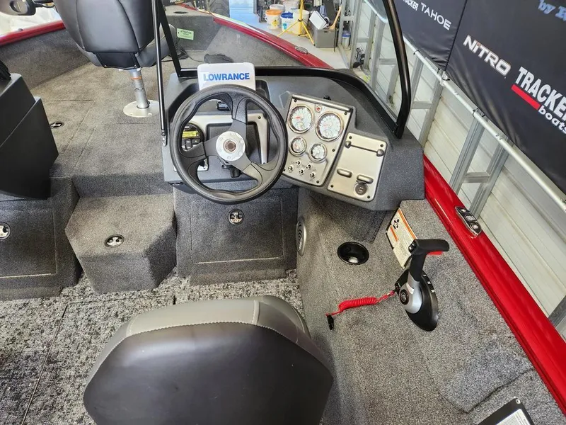 Slide: The Image of 2025 Tracker Pro Guide V-175 Combo boat interior with steering wheel and control panel. - 4