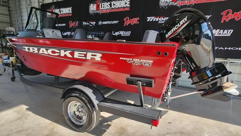Slide: The Image of 2025 Tracker Pro Guide V-175 Combo boat, red, on trailer in showroom. - 5
